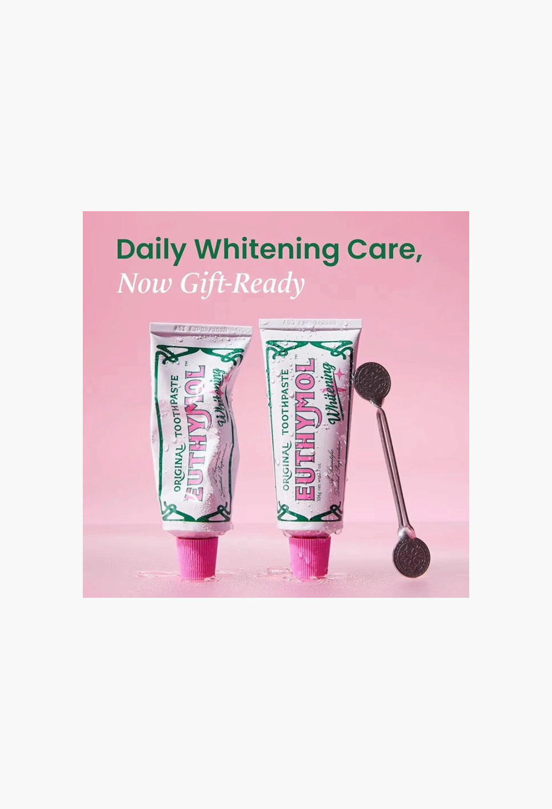 GLAM MODA EUTHYMOL whitening toothpaste gift set with two tubes and a metal squeezer on a pink background
