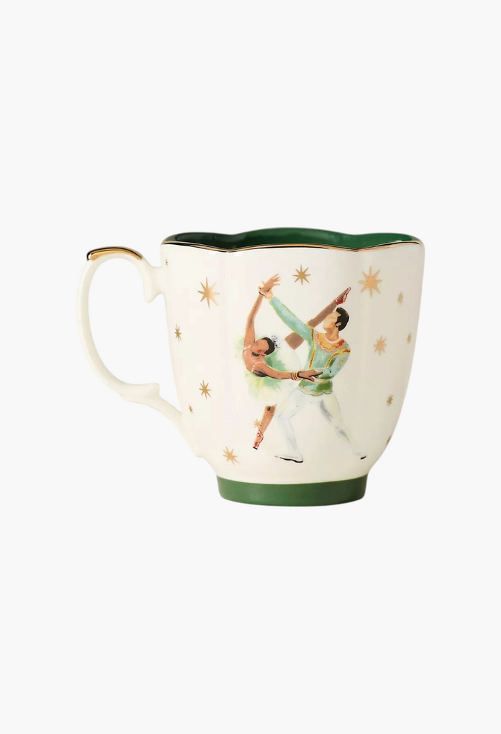 GLAM MODA stoneware mug featuring a Nutcracker ballet dancer illustration with gold star accents and green trim.