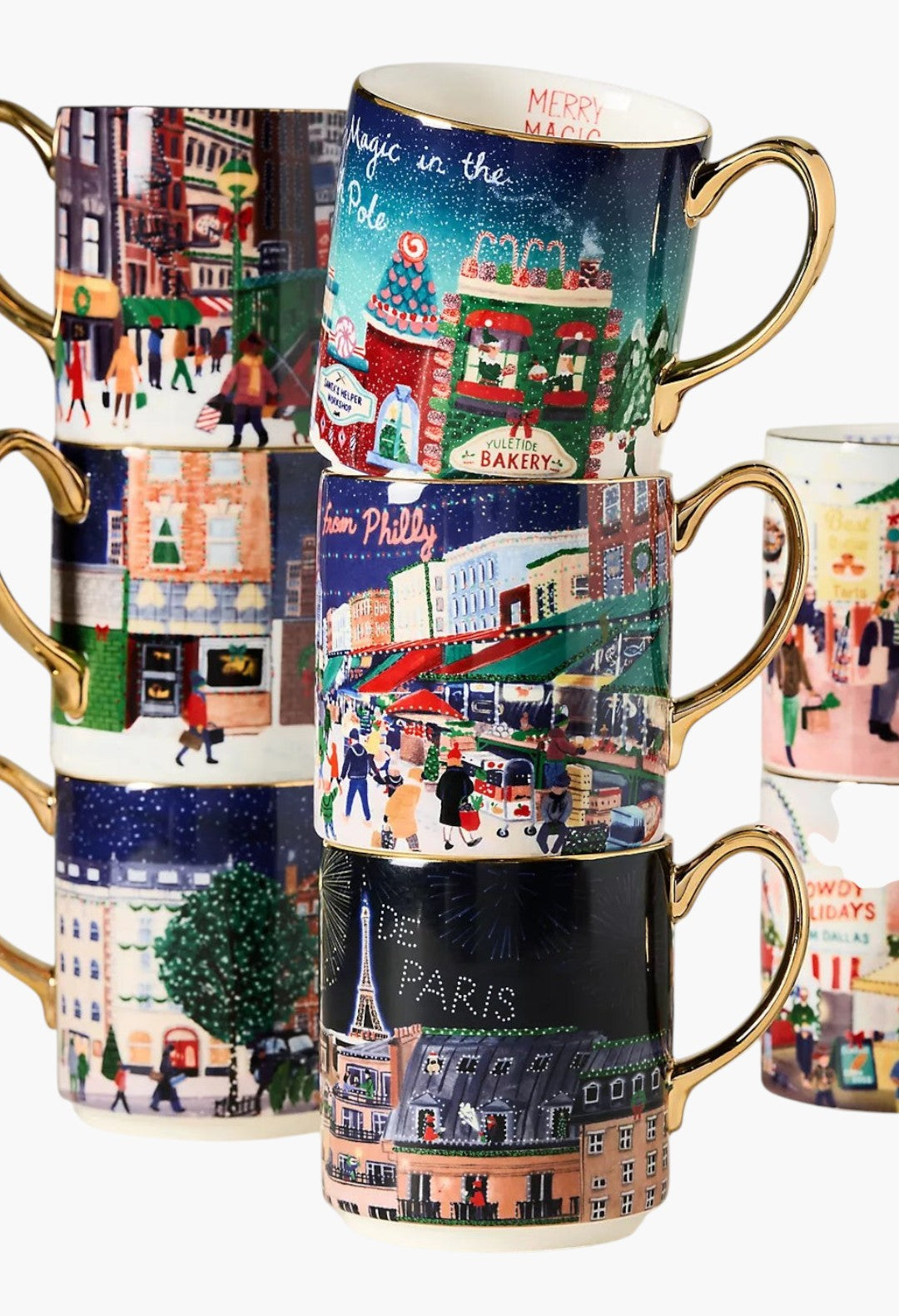 GLAM MODA Holiday in the City stoneware mugs stacked, featuring festive streetscapes and hand-painted gold handles.