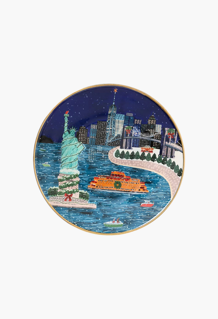 GLAM MODA Holiday in the City stoneware dessert plate featuring a festive New York skyline with gold rim accents.
