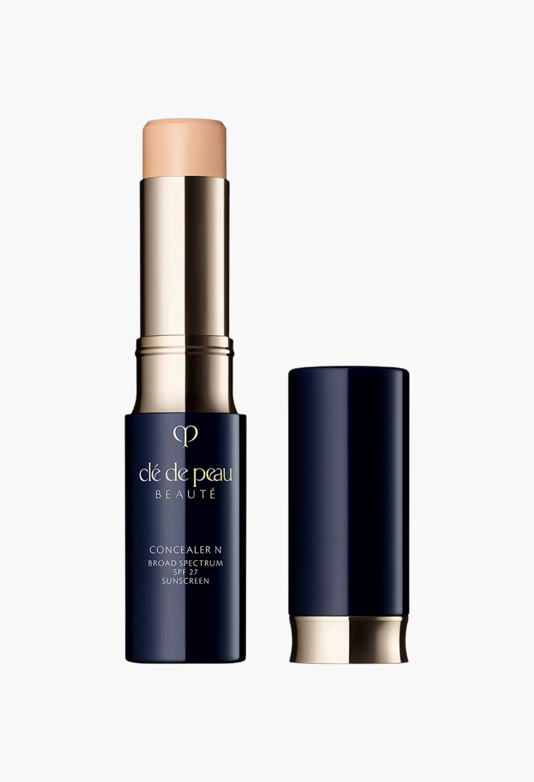 GLAM MODA Clé de Peau Beauté Concealer SPF 27 stick in a navy blue tube with gold accents for full coverage makeup