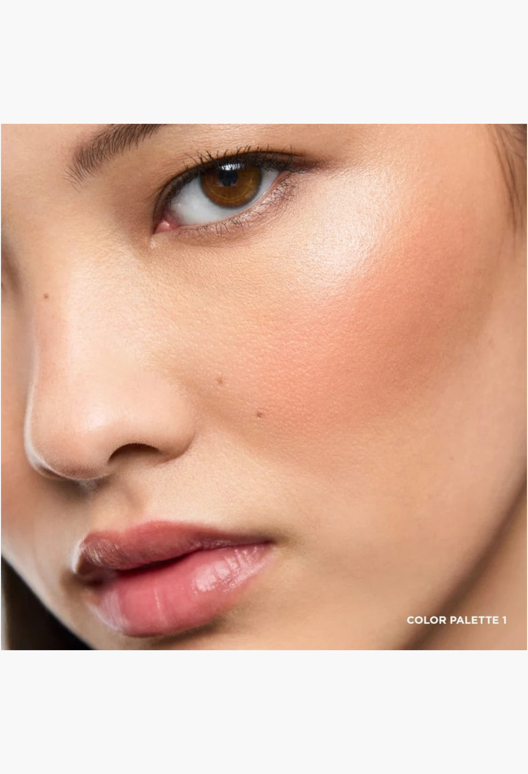 GLAM MODA Ambient Lighting Edit Unlocked Color Palette 1 swatched on a model's cheek for a radiant, lit-from-within glow.