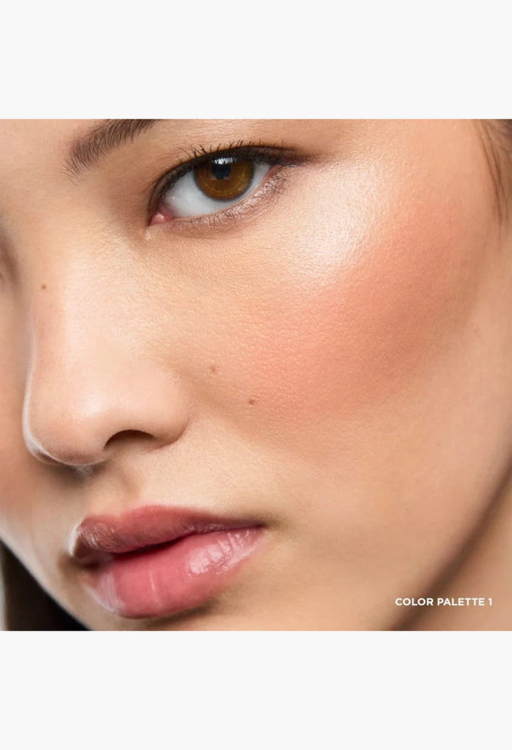 GLAM MODA Ambient Lighting Edit Unlocked Color Palette 1 applied as a soft, radiant peach blush on a model's cheek.