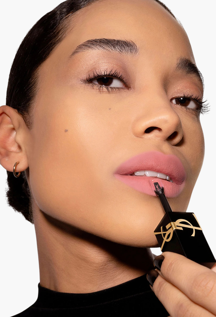 GLAM MODA model applying Yves Saint Laurent The Inks Blurring Matte Liquid Lip Stain in a soft pink shade