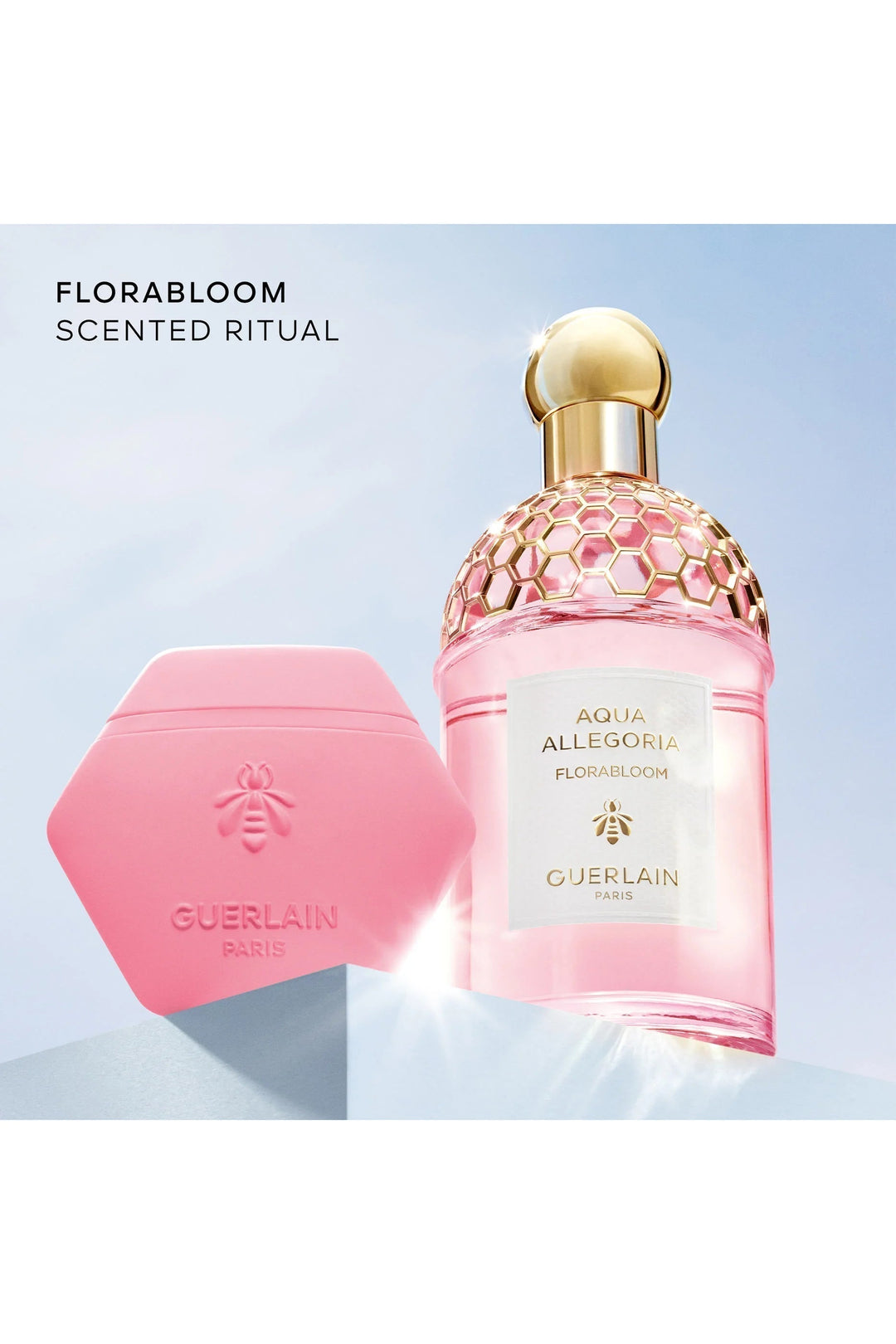 GLAM MODA Guerlain Aqua Allegoria Florabloom hand cream in a pink honeycomb tube next to the matching floral perfume