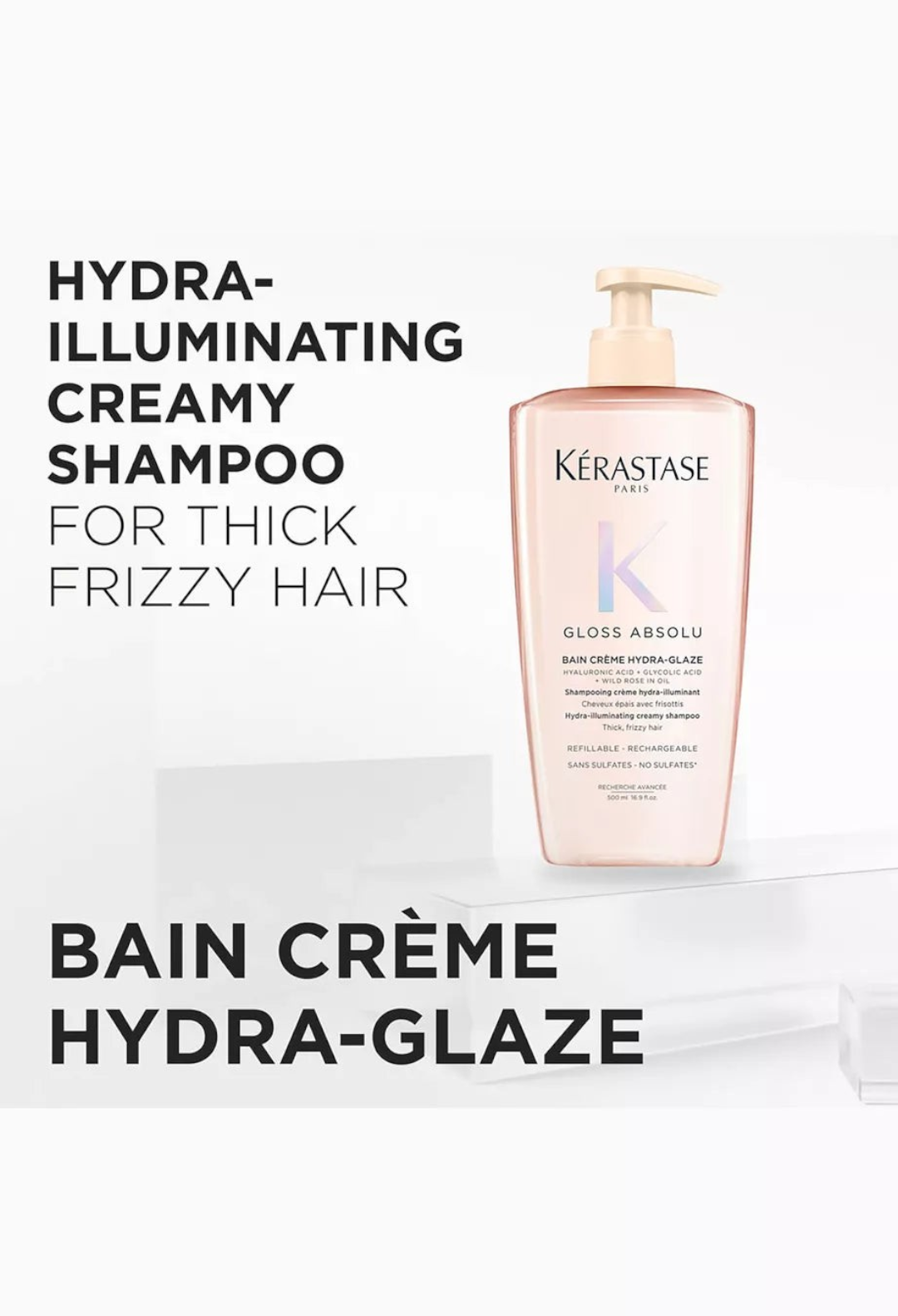 GLAM MODA Kérastase Gloss Absolu Hydra-Glaze refillable shampoo bottle for thick, frizzy hair on a white pedestal.
