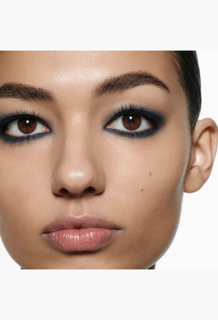 Model wearing a bold, smoky navy blue eye look created with the GLAM MODA Eye Wardrobe Multi-Finish Eyeshadow Palette.