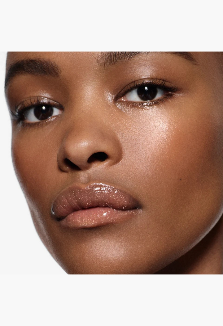 GLAM MODA Posh Gloss applied to a model's lips, showing a high-shine, sheer, and shimmering finish.