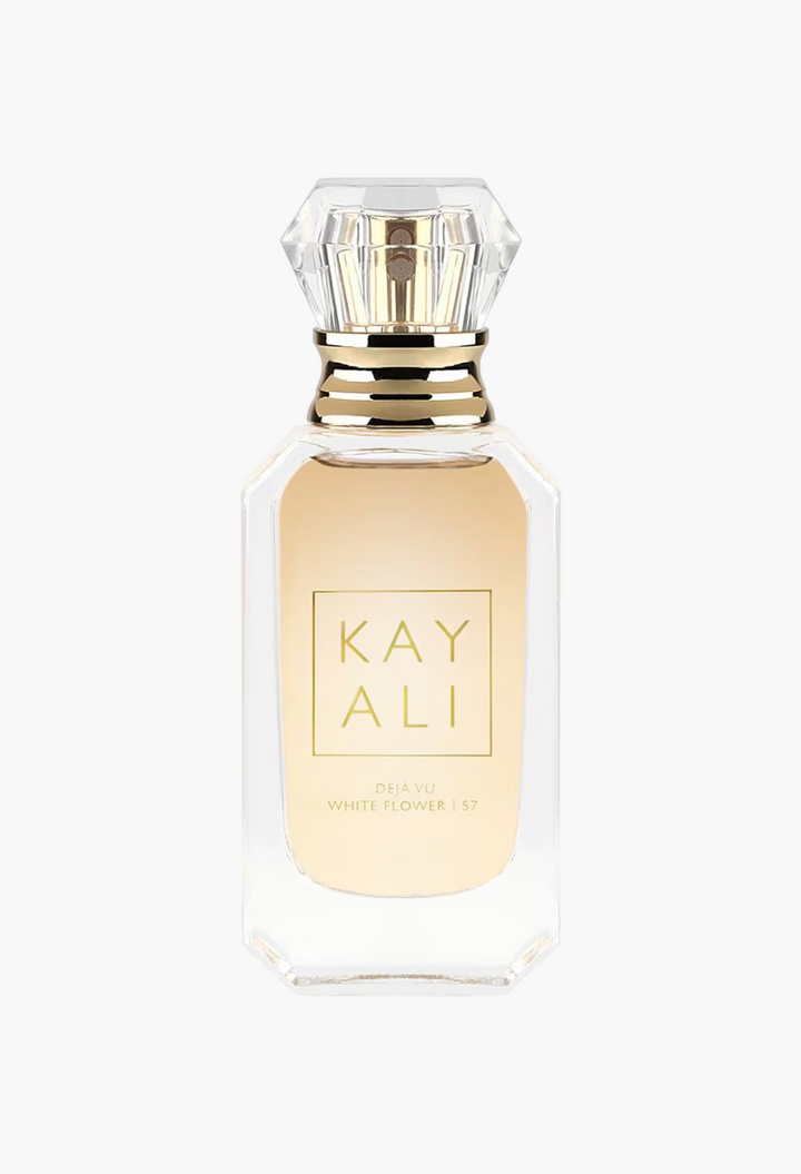 GLAM MODA Kayali Déjà Vu White Flower 57 perfume bottle with a gold label and diamond-shaped crystal cap.
