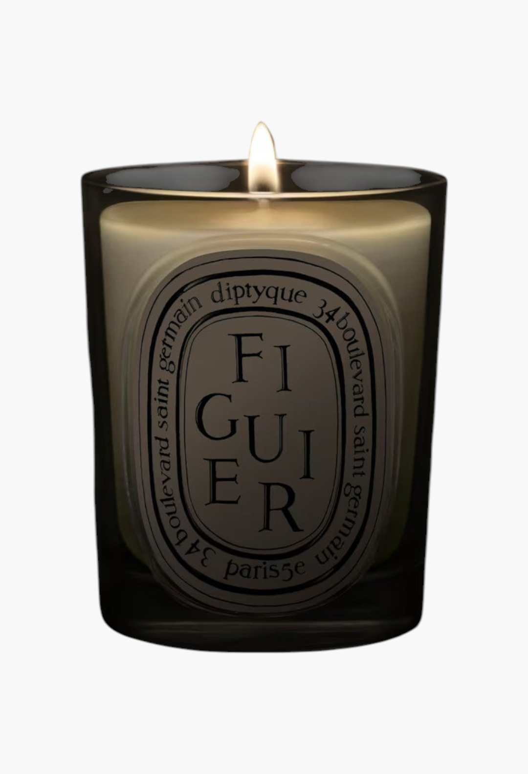 GLAM MODA Figuier candle in a clear glass jar with a lit wick, featuring woody and fresh Mediterranean fig scents.