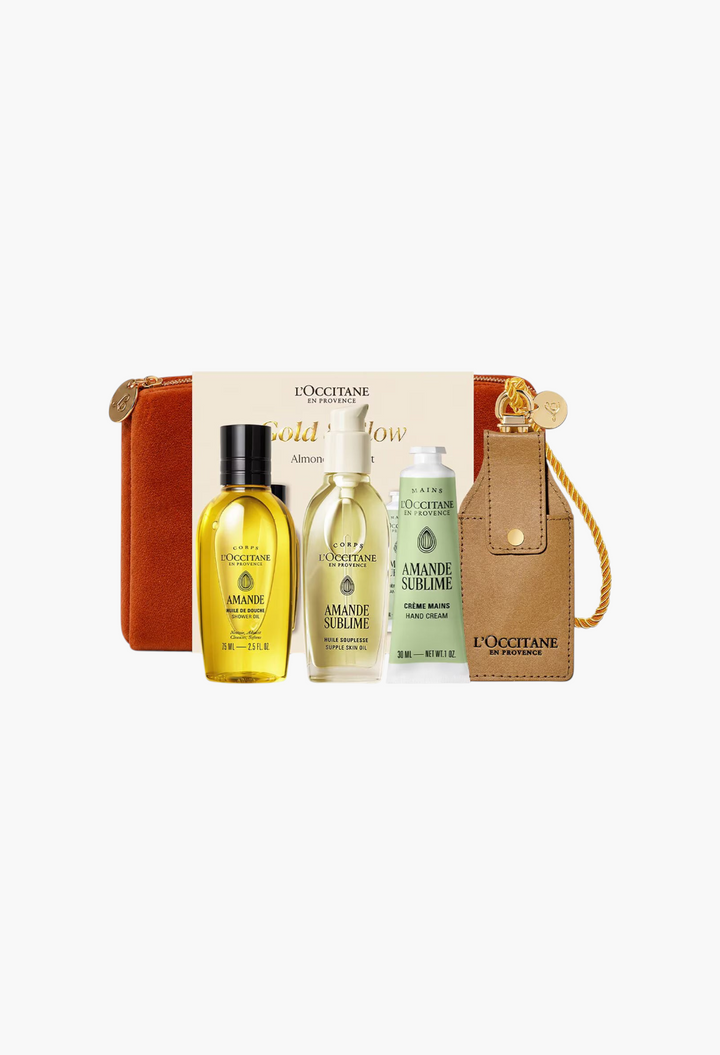 GLAM MODA Gold & Glow Almond set featuring shower oil, supple skin oil, hand cream, and a velvet pouch.