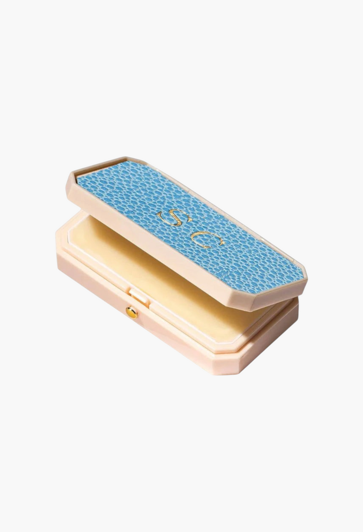 GLAM MODA Baume des Muses Ivory lip balm in a customizable blue textured case with gold embossed initials