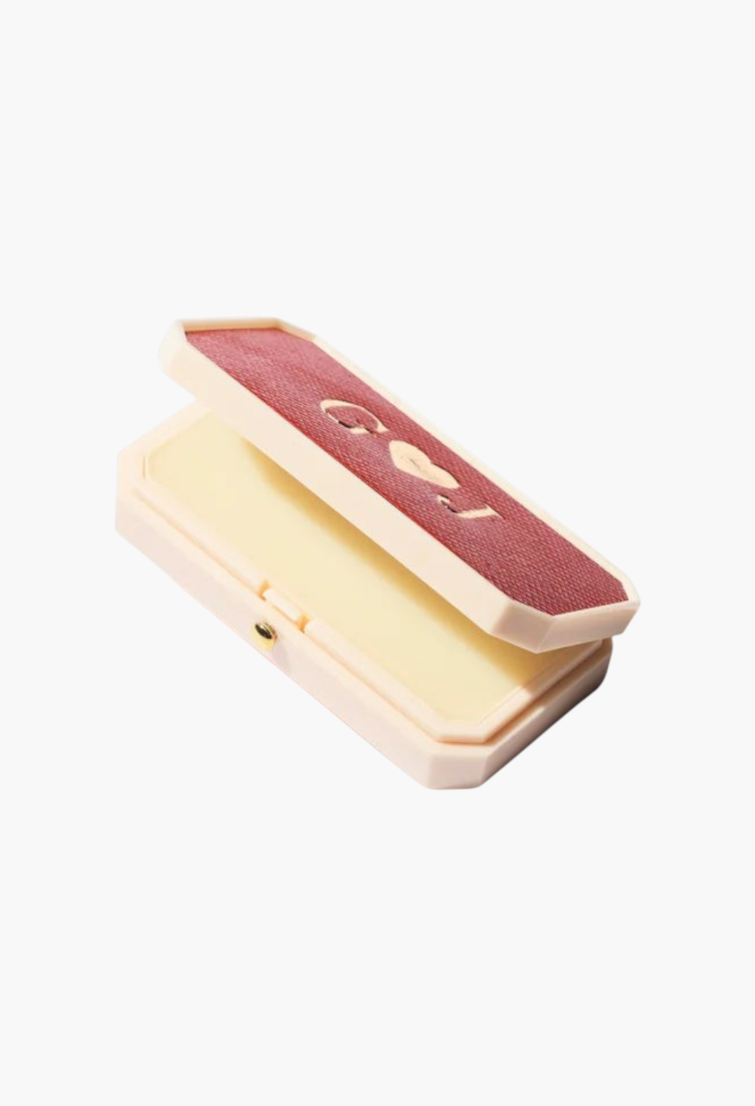 GLAM MODA Baume des Muses Ivory lip balm in a vintage-style rectangular case with a red textured lid and gilt initials.