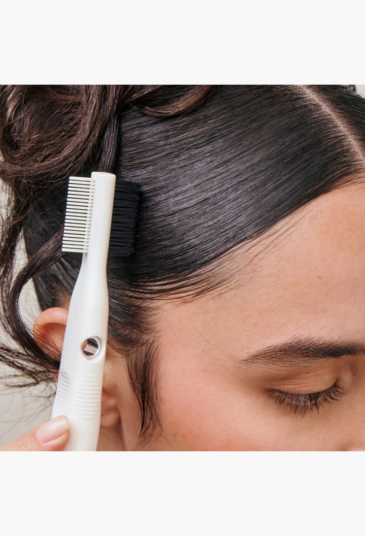 GLAM MODA Strong Hold Gel used with a dual-sided edge brush to smooth and sculpt sleek hair edges.