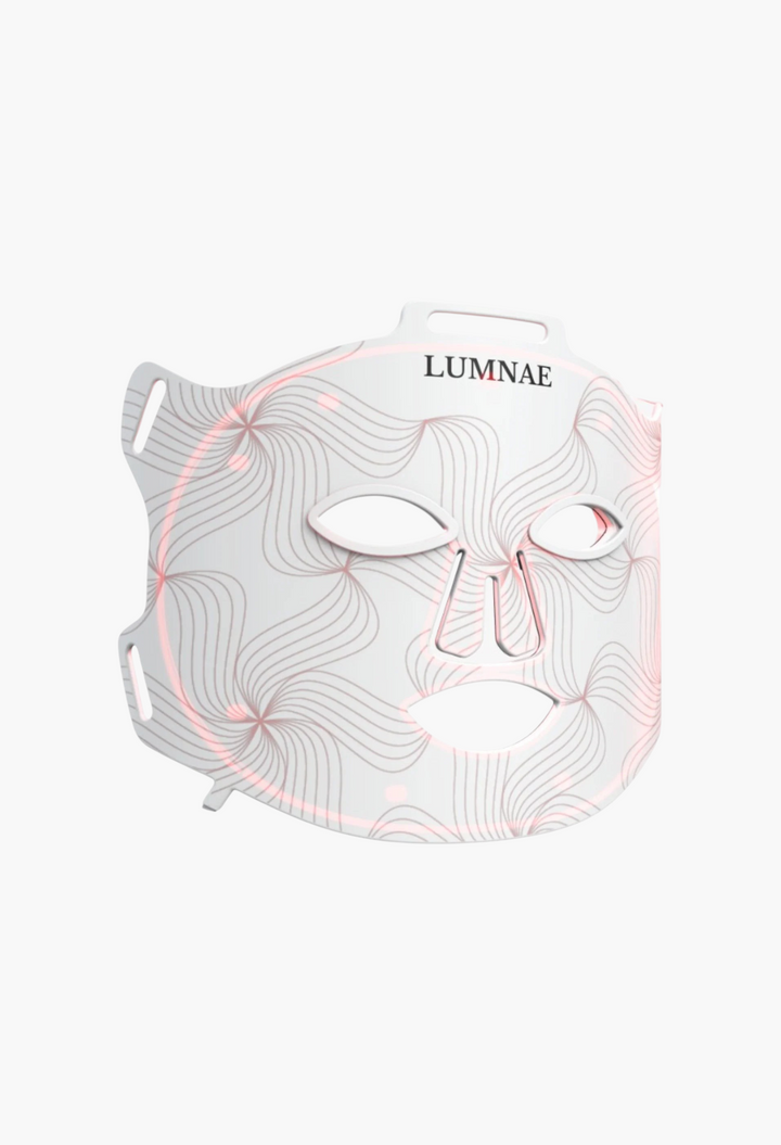 GLAM MODA Lumnae LED light therapy mask in white silicone with intricate line patterns and glowing red light therapy