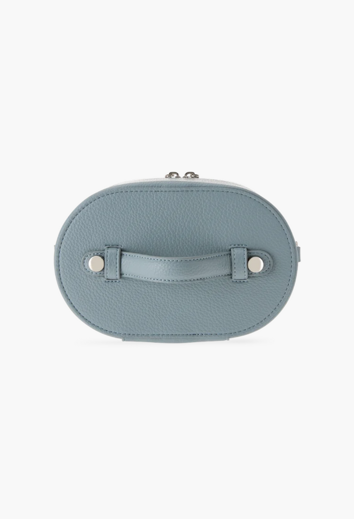 GLAM MODA oval toiletry case in blue vegan leather with a top handle and silver hardware, top-down view.