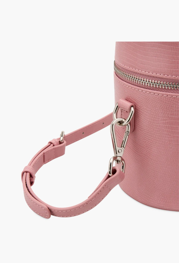 GLAM MODA pink vegan leather oval toiletry case with a detachable shoulder strap and silver hardware detail.