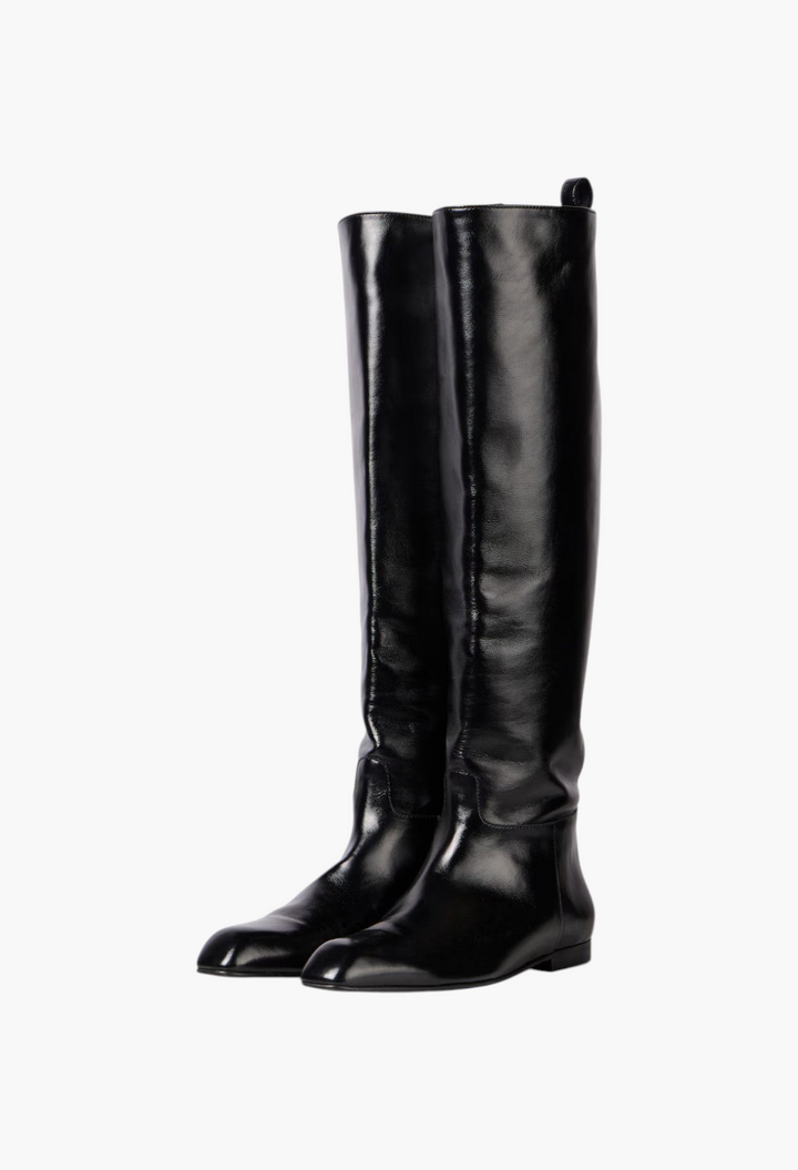 GLAM MODA Colt black leather knee-high boots with an almond toe and low heel, displayed on a marble surface.