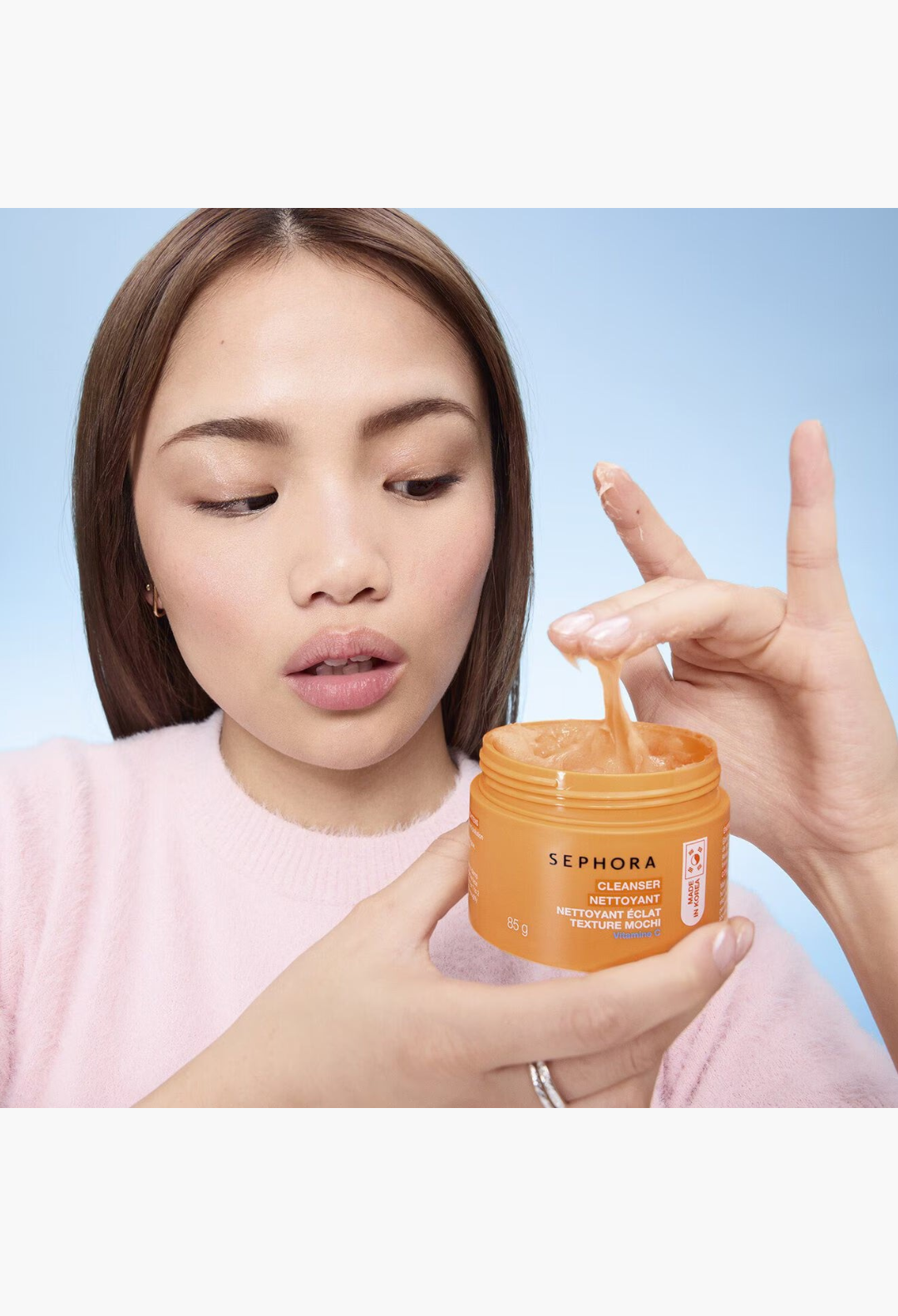 GLAM MODA model demonstrating the orange mochi texture of Sephora Collection Vitamin C brightening facial cleanser