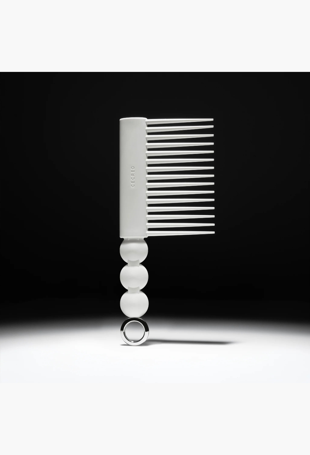 GLAM MODA Rake Comb in matte white with long tapered teeth and a decorative spherical handle with a metal ring.
