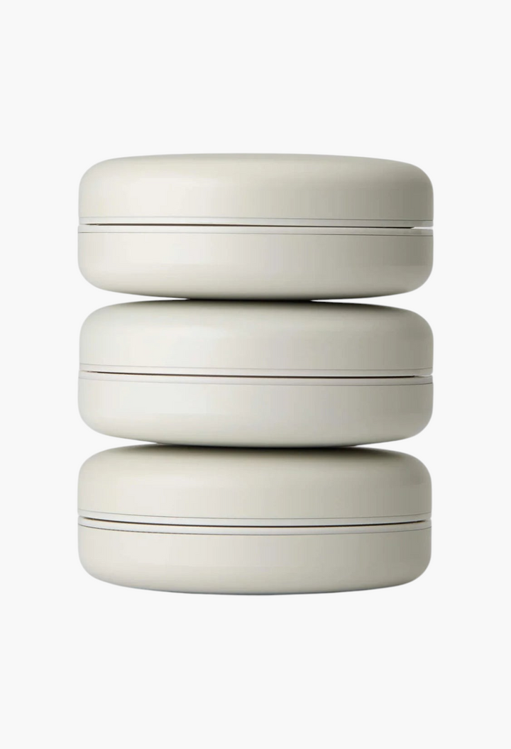 GLAM MODA Le Balm Trois unscented solid serum trio stacked in three minimalist beige round containers