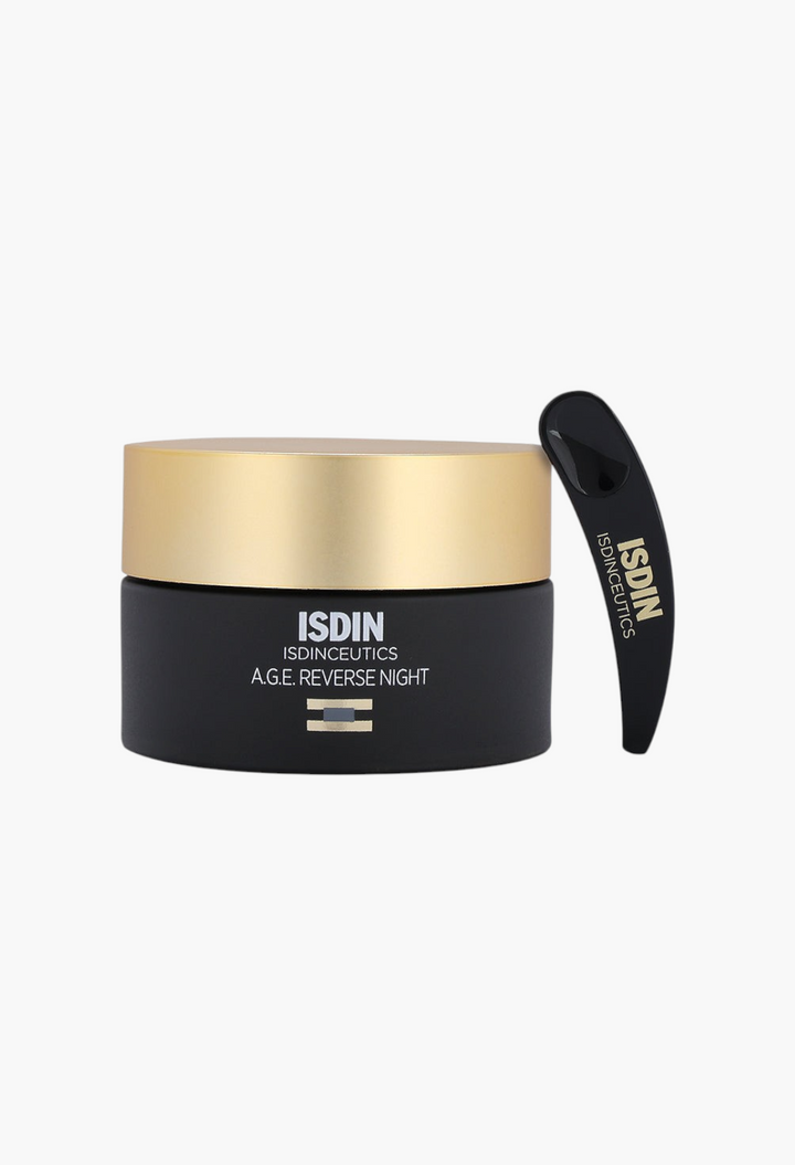 GLAM MODA Isdinceutics A.G.E. Reverse Night Cream in a black jar with a gold lid and a black application spatula.