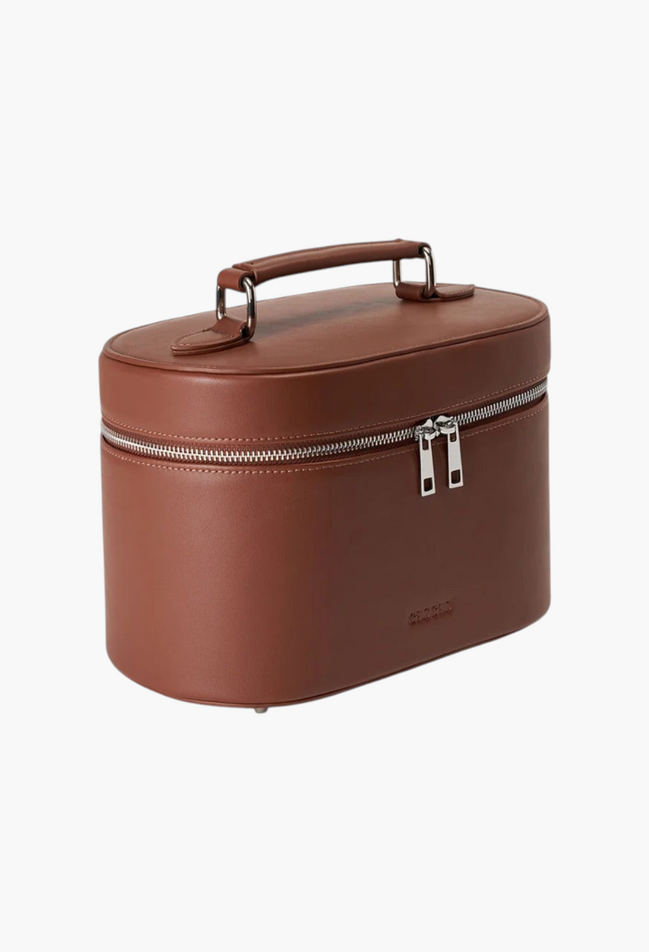 GLAM MODA espresso brown oval makeup vanity case in premium vegan leather with silver hardware and top handle.