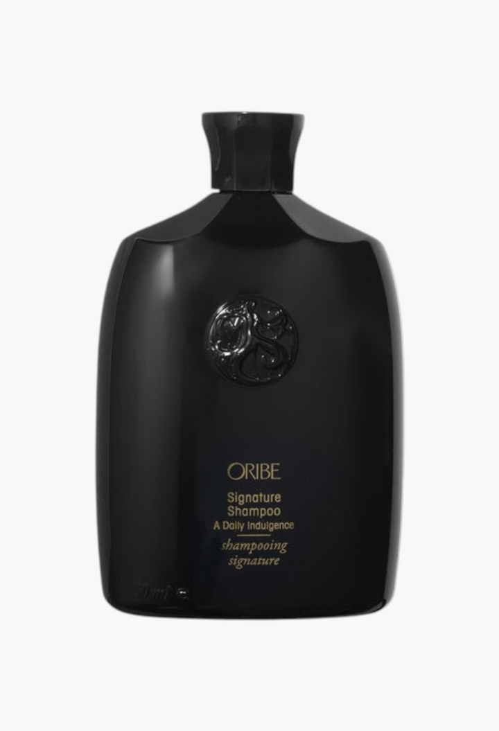 GLAM MODA Oribe Signature Shampoo in a sleek black bottle with gold lettering for daily hair nourishment and shine