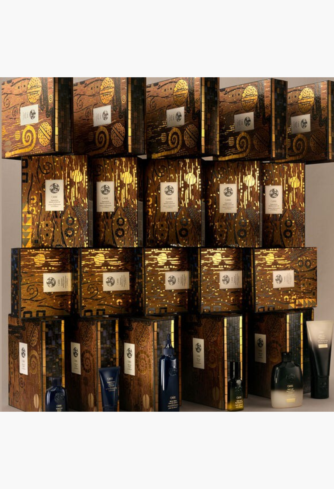 GLAM MODA Oribe Gold Lust haircare gift set featuring shampoo, conditioner, and nourishing oil in decorative boxes.