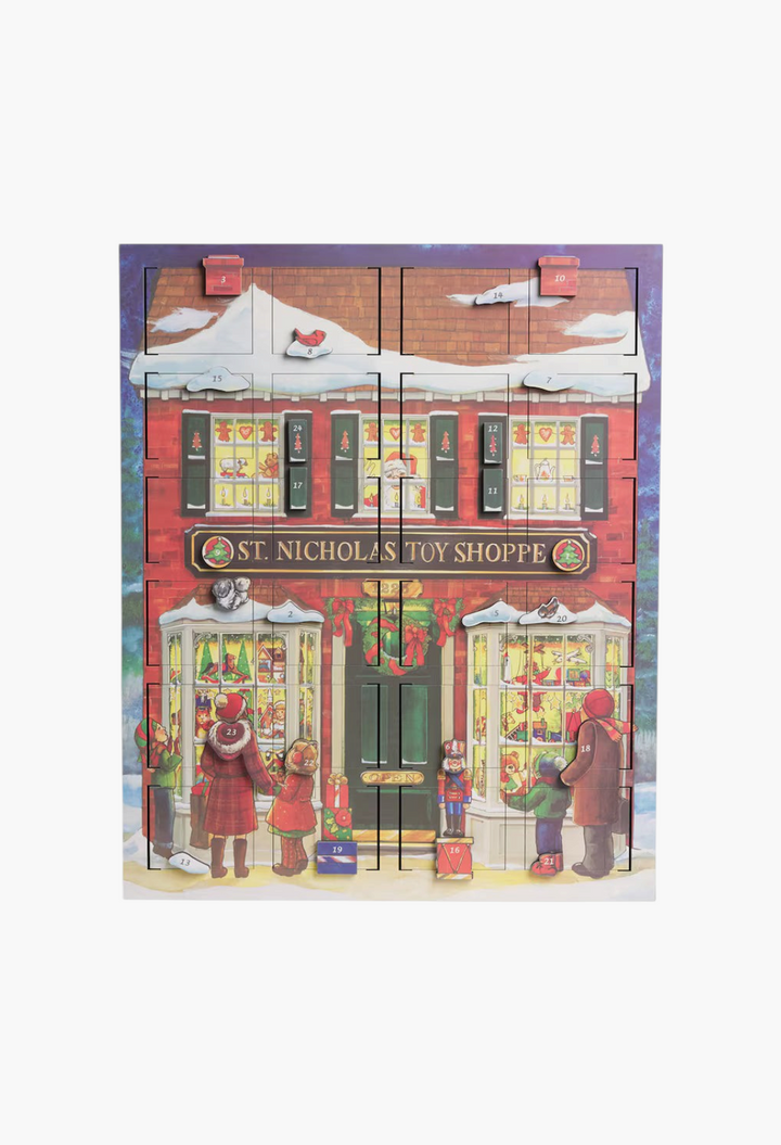 GLAM MODA wooden advent calendar featuring a festive St. Nicholas Toy Shoppe scene with 24 numbered doors.