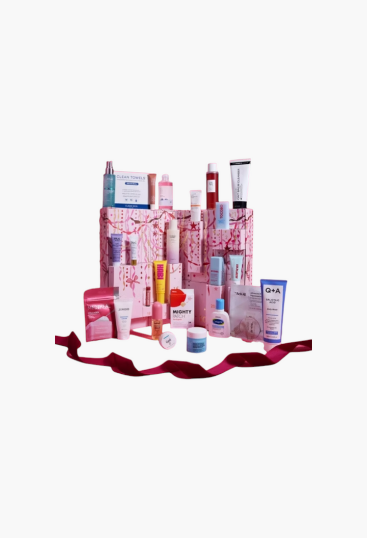 GLAM MODA 24 Days of Skin advent calendar featuring various skincare products arranged on a pink festive background.