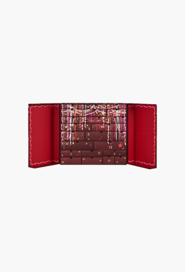 GLAM MODA 24-day beauty advent calendar in deep red with festive pink ribbon and star illustrations on pull-out drawers.
