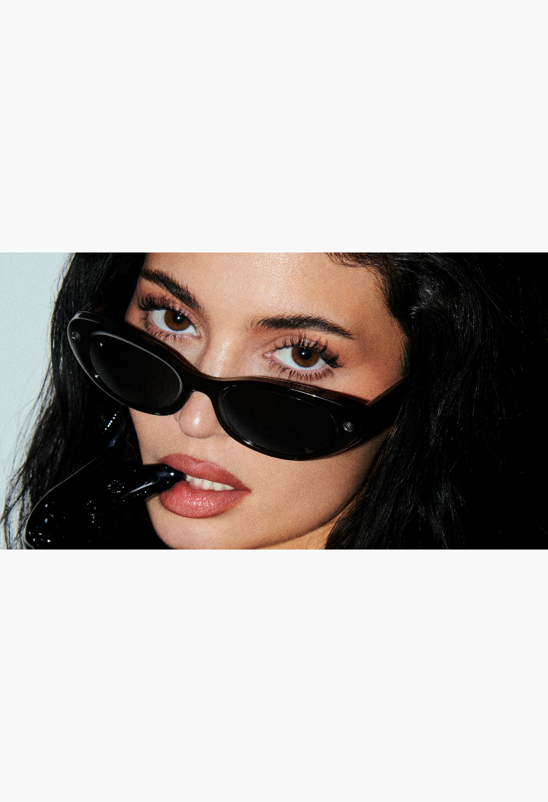 GLAM MODA Starfire Kylie Edition smart glasses with a slim black oval frame worn by Kylie Jenner in a close-up shot