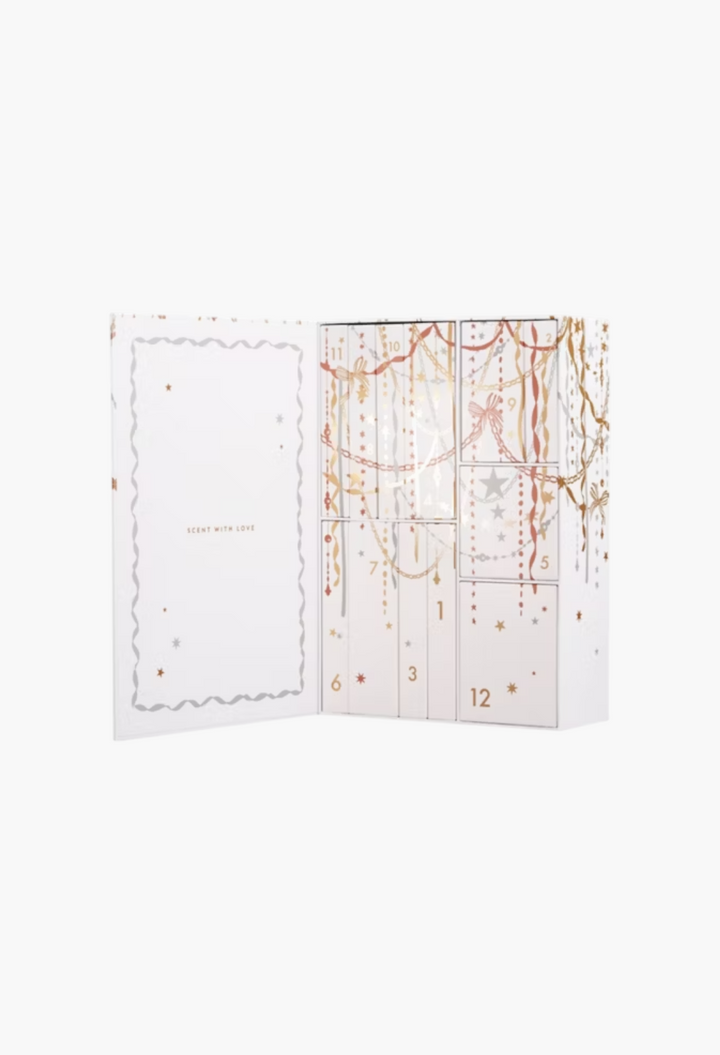 GLAM MODA 12 Days of Scent fragrance advent calendar in a white keepsake box with gold and silver festive decorations.