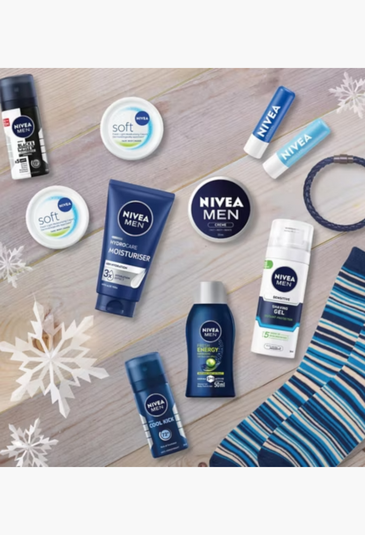 GLAM MODA NIVEA MEN advent calendar featuring skincare, grooming products, a bracelet, and socks on a wooden surface.