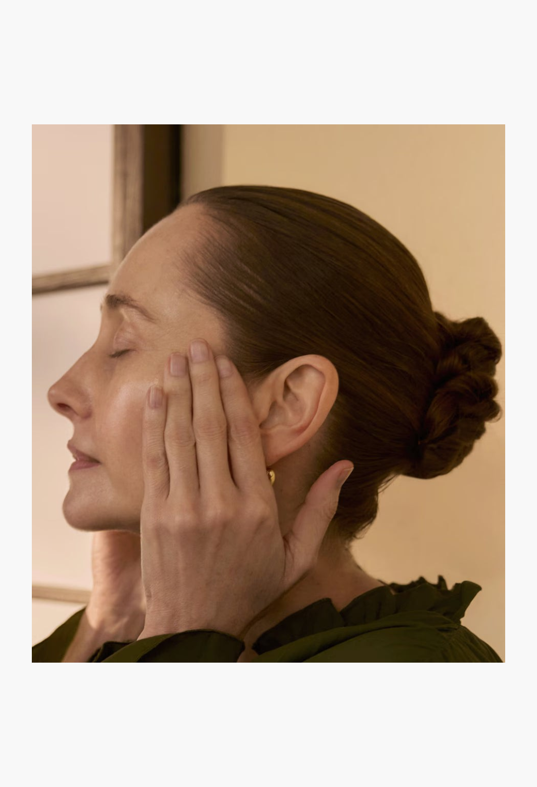 GLAM MODA model applying Sensai Ultimate The Concentrate to her face for a radiant and firm skin transformation