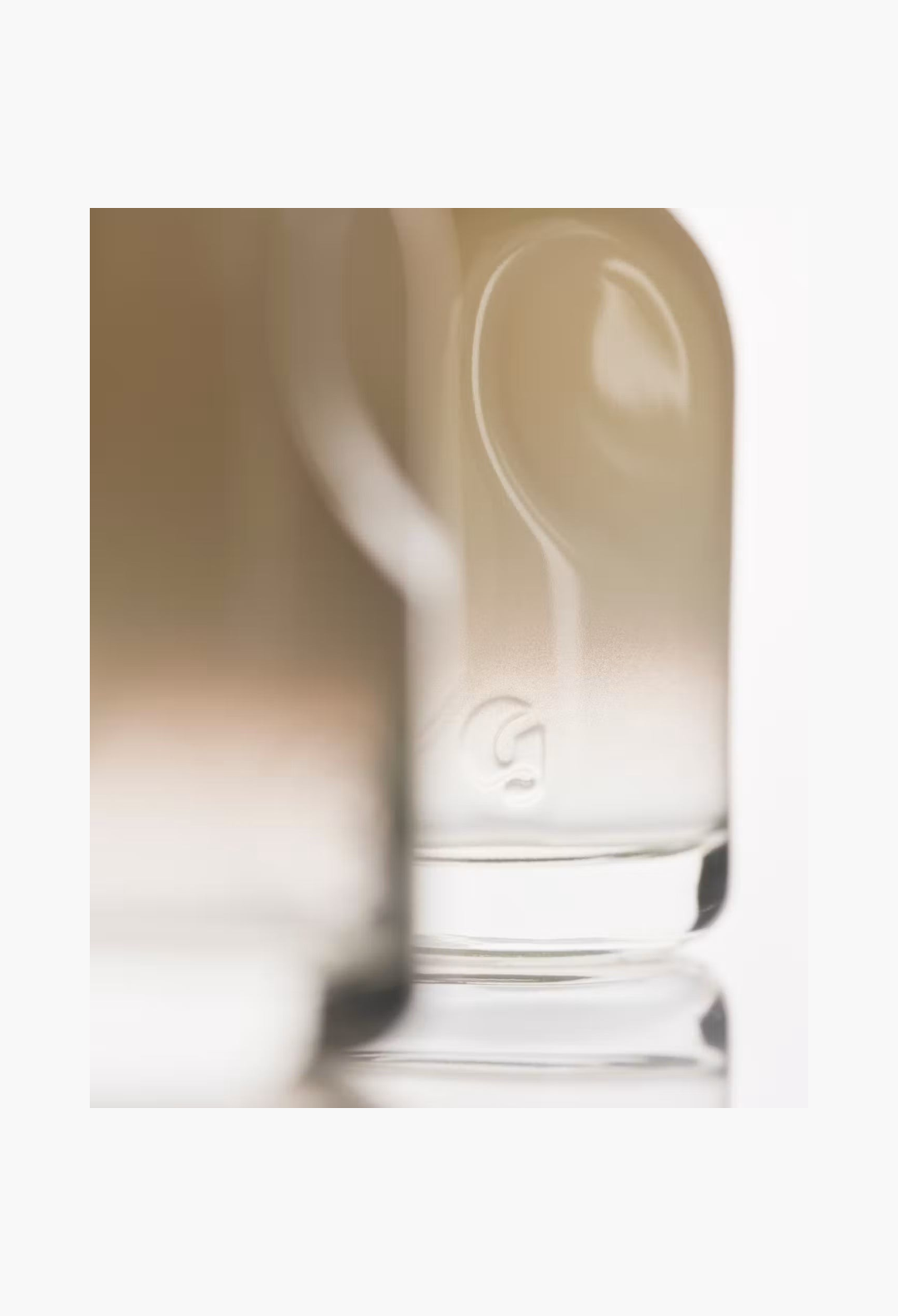 GLAM MODA Glossier You Doux eau de parfum bottle featuring a soft gradient glass design with embossed logo detail.