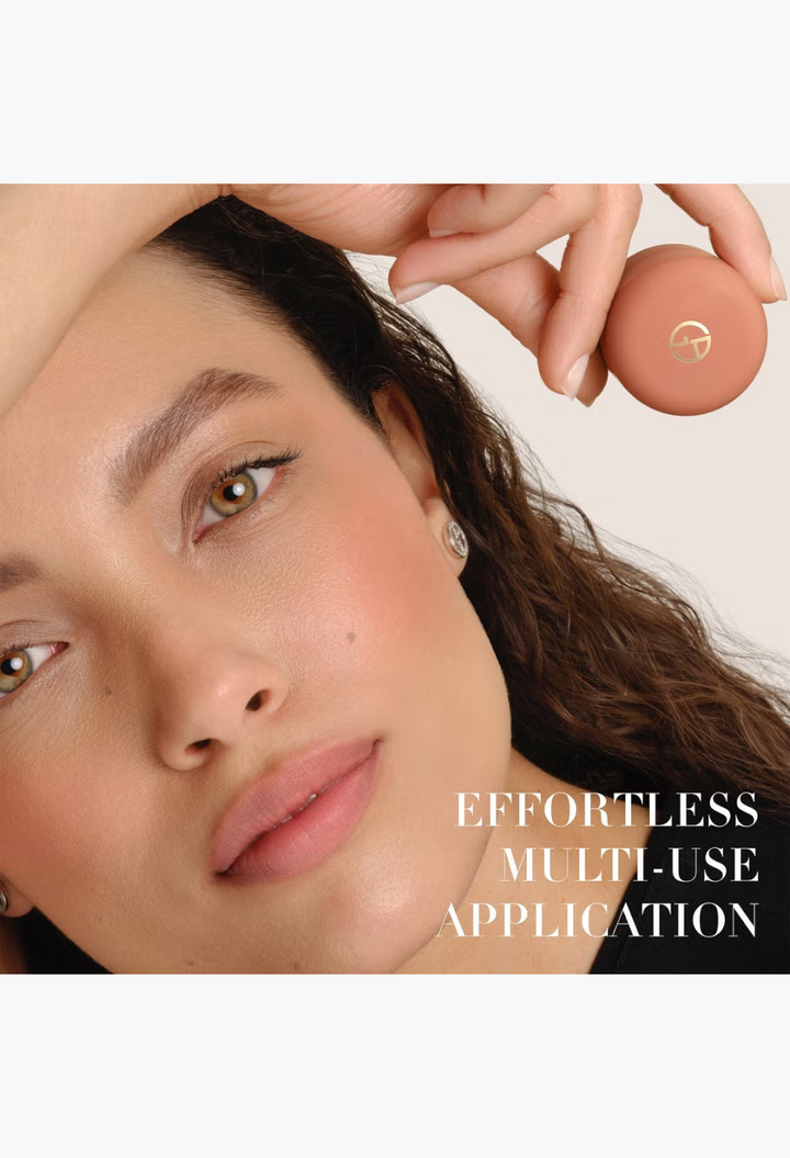 GLAM MODA Armani Beauty Dolci Blush stick held by a model with a natural, radiant makeup finish on cheeks and lips.