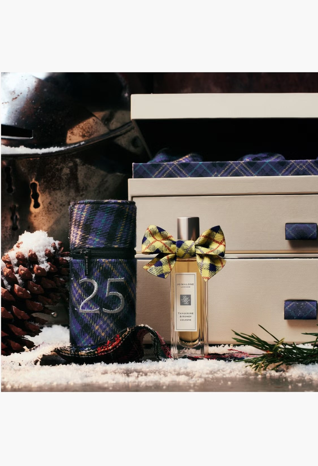 GLAM MODA Jo Malone London Tangerine & Honey cologne bottle adorned with a festive yellow and blue plaid ribbon bow.