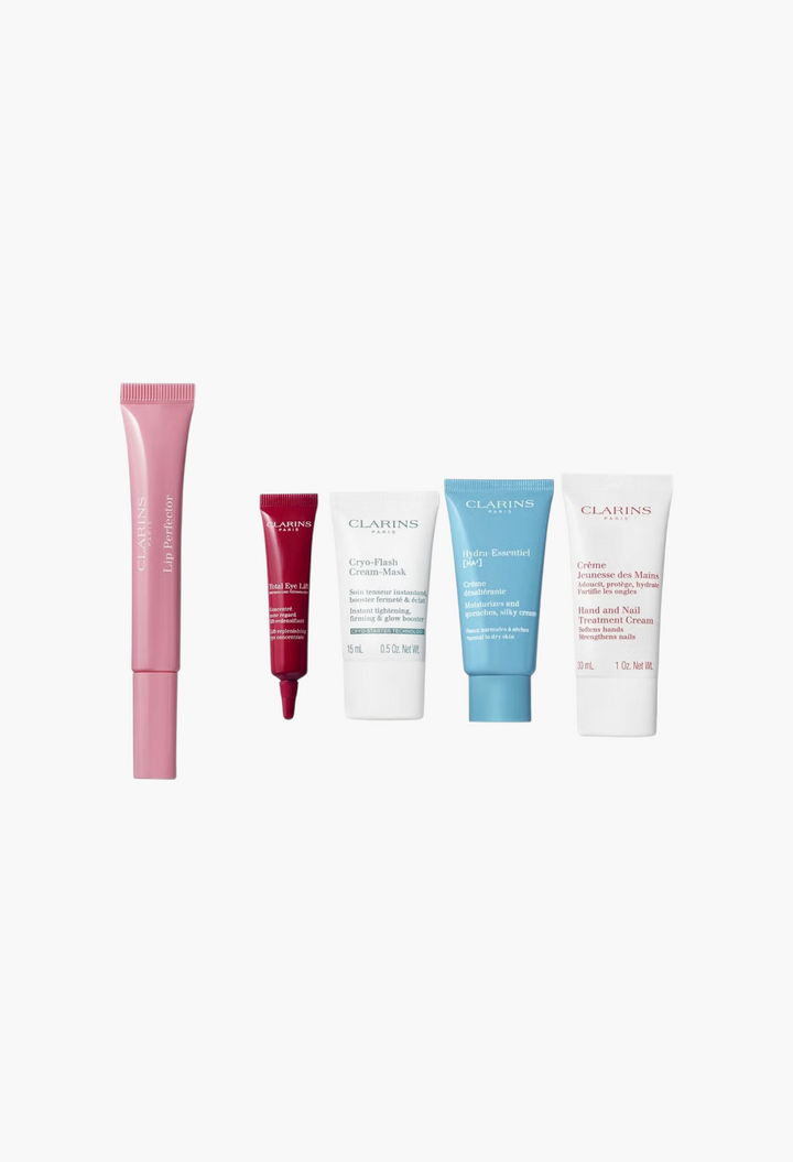 GLAM MODA Clarins 12 Day Beauty Calendar featuring five skincare and makeup travel-sized tubes on a white background.