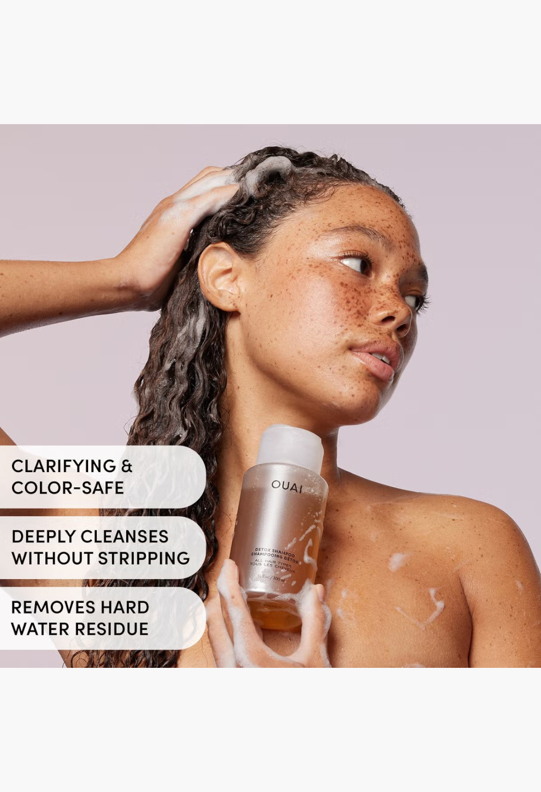 GLAM MODA OUAI Detox Shampoo being applied by a woman with long wavy hair to cleanse and clarify her strands