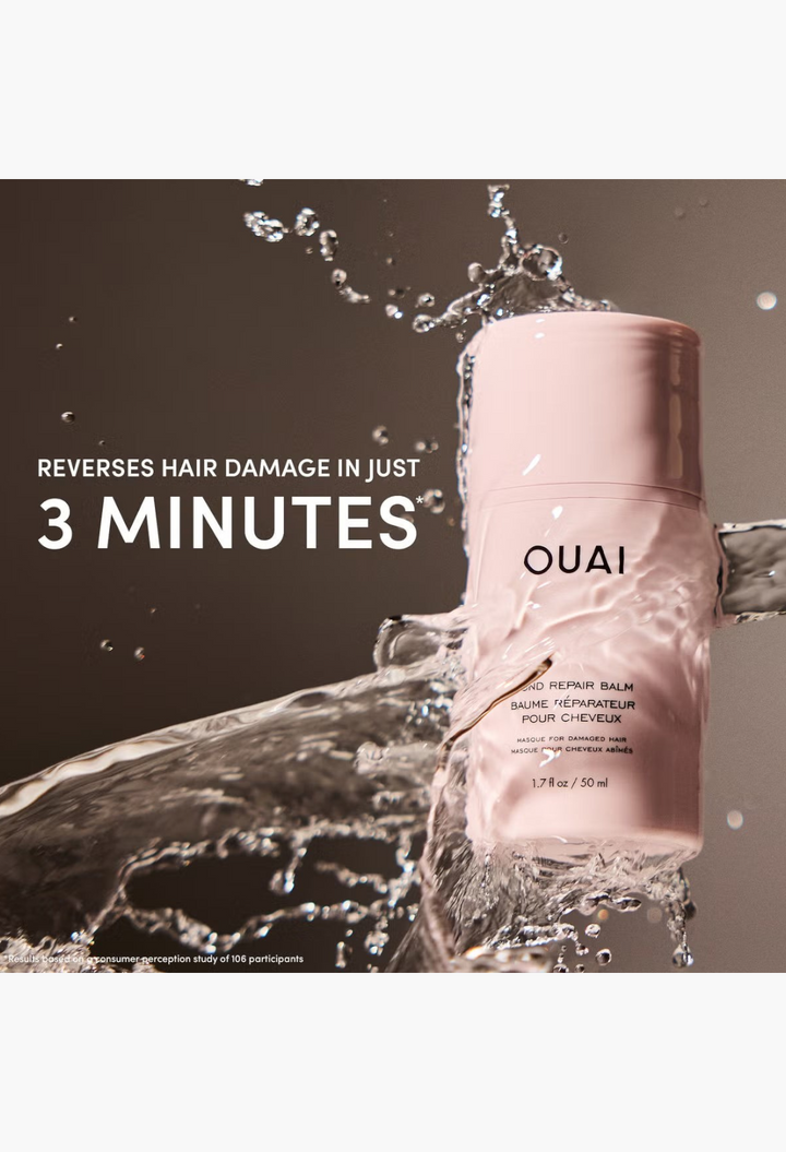 GLAM MODA OUAI Bond Repair Balm in a pale pink bottle surrounded by a dynamic splash of water for a hydrating effect.