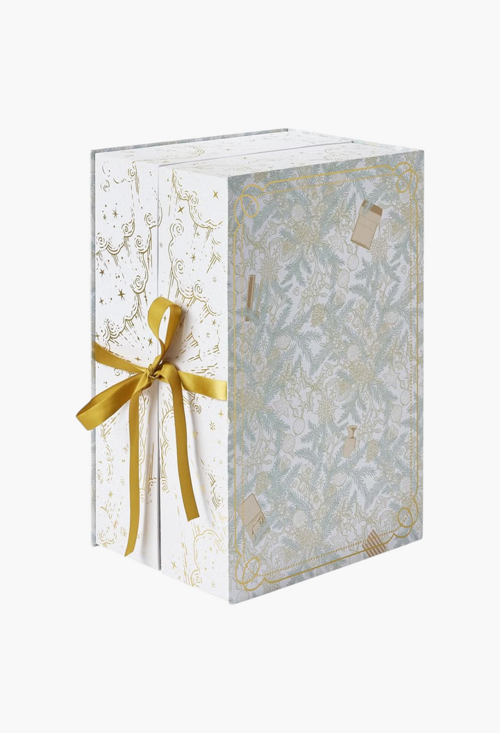 GLAM MODA beauty advent calendar featuring intricate botanical illustrations and a gold ribbon closure.