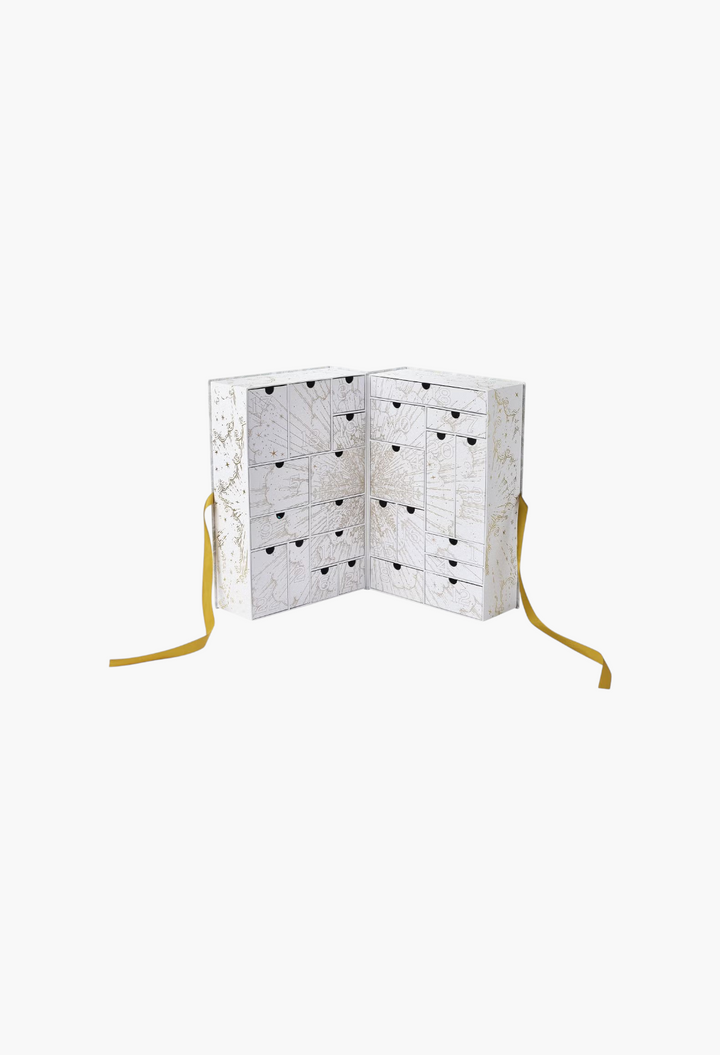 GLAM MODA beauty advent calendar with white and gold botanical illustrations and numbered drawers for holiday gifts.