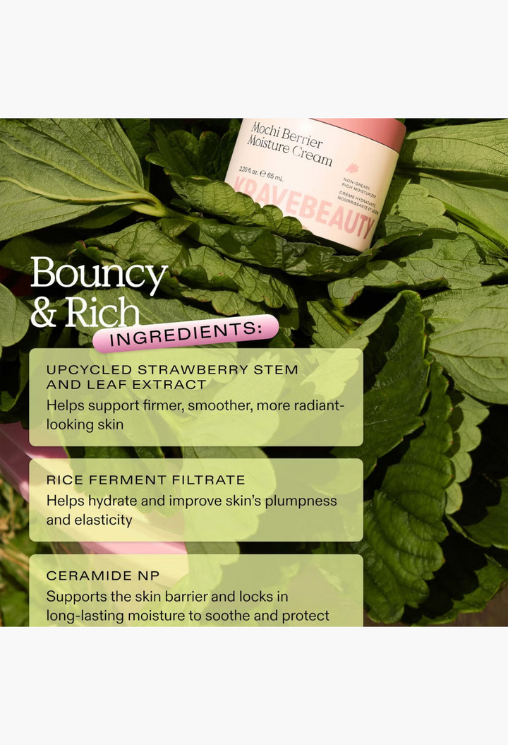 GLAM MODA KraveBeauty Mochi Berrier Moisture Cream jar resting on fresh green strawberry leaves with ingredient list