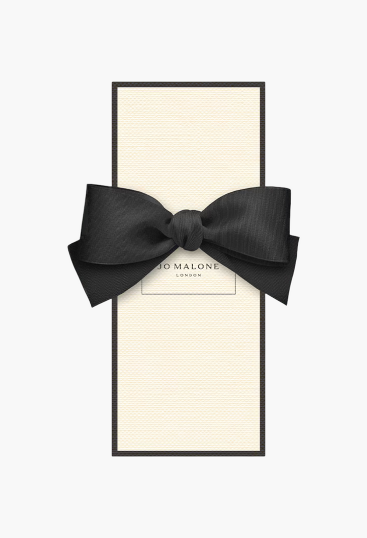 GLAM MODA Grapefruit Cologne in a rectangular cream box with a black border and a decorative black ribbon bow.