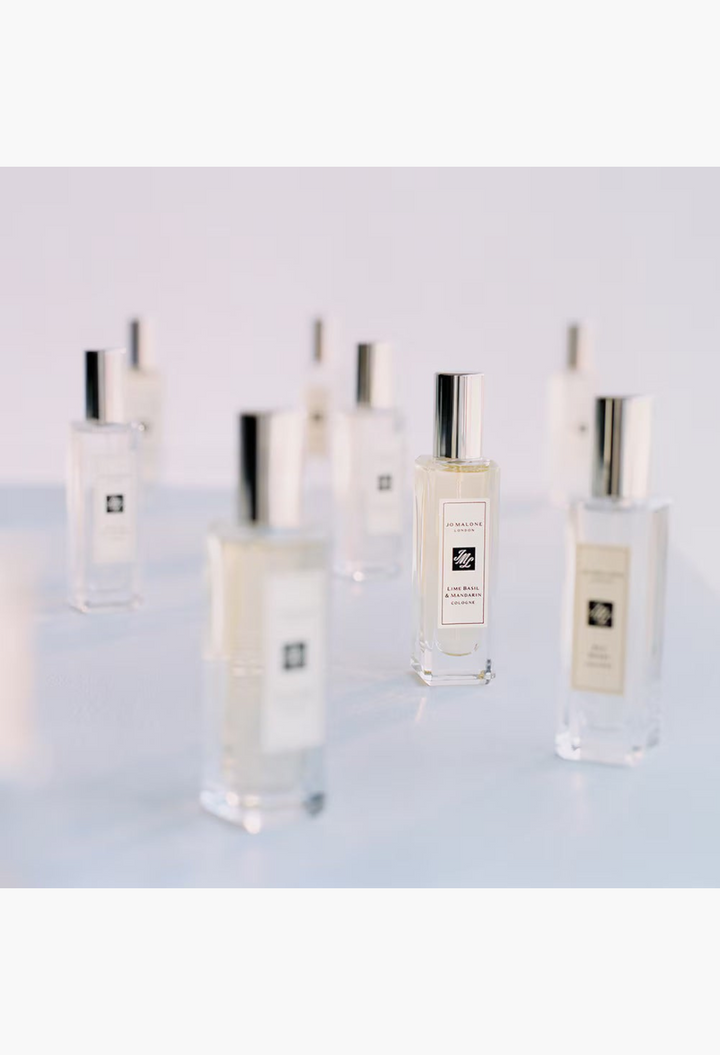 GLAM MODA collection of Jo Malone London cologne glass bottles with silver caps arranged on a white background