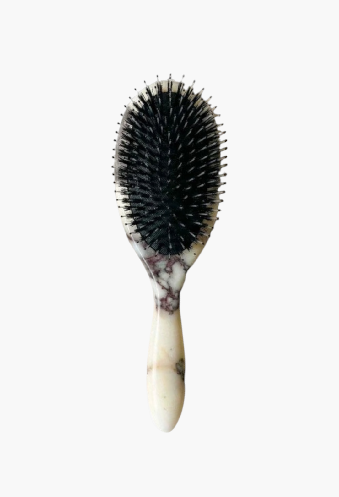 GLAM MODA hand-carved Calacatta Viola marble hairbrush with black boar and nylon bristles on a stone surface