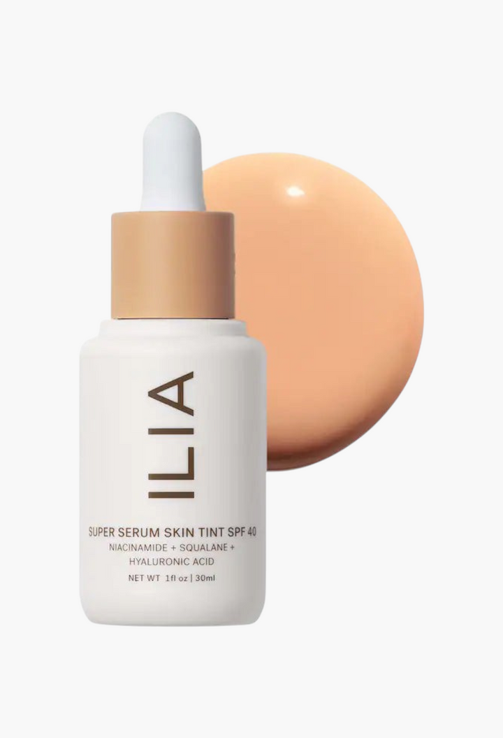 GLAM MODA ILIA Super Serum Skin Tint SPF 40 bottle with a swatch of liquid foundation on a white background