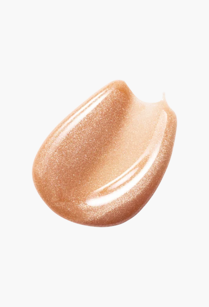 GLAM MODA Posh Gloss swatch featuring a shimmering nude peach high-shine lip gloss texture on a white background.